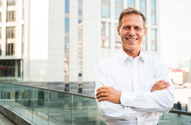 Businessman smiling with arms crossed