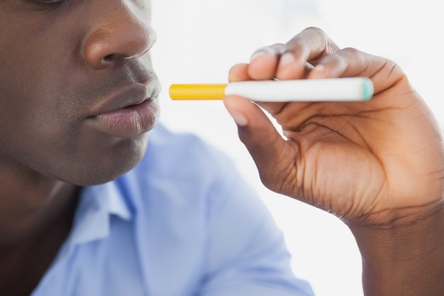 Businessman smoking an electronic cigarette