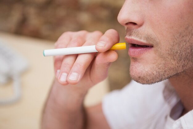 Businessman smoking an electronic cigarette