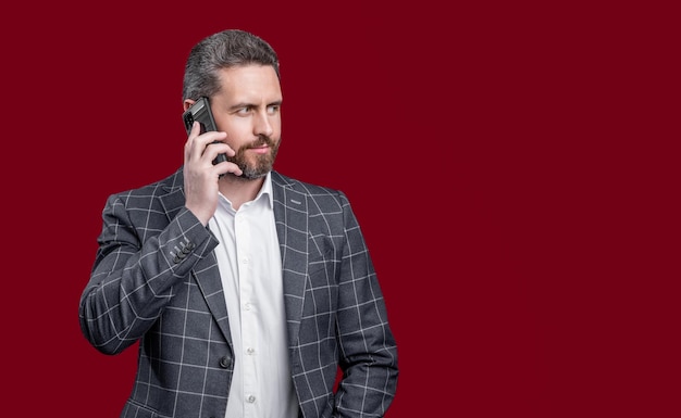 Businessman speak on phone photo of businessman speak on phone formal businessman speak on phone isolated on red background businessman in formal menswear speak on phone in studio