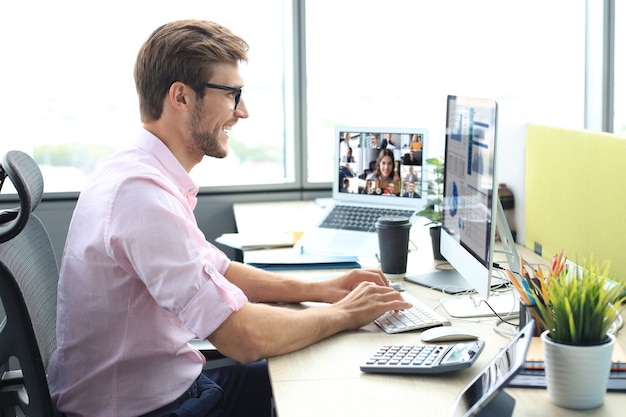 Businessman speak talk on video call with colleagues on online briefing during self isolation