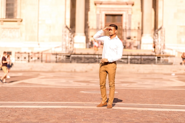 A businessman on a square covering his face