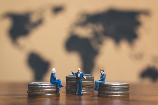 Photo businessman on stack of coin, money and financial business success concept.