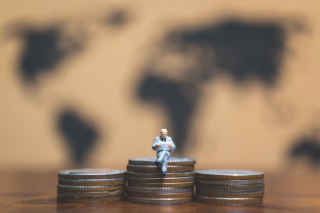  Businessman on stack of coin, money and financial business success concept. 