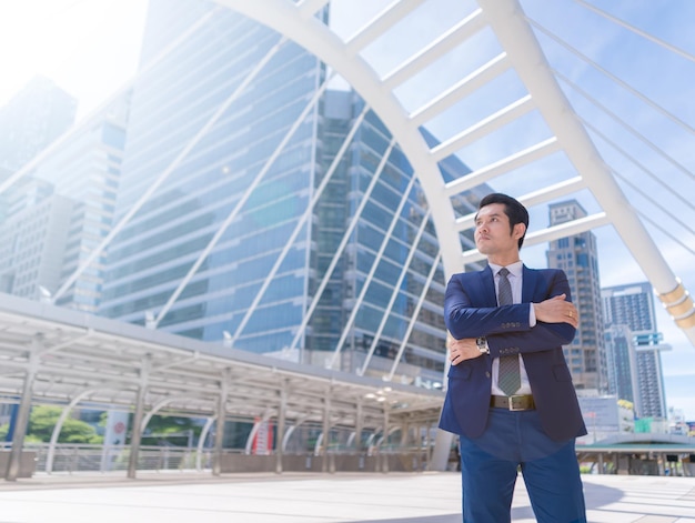 Businessman standing against buildings in city