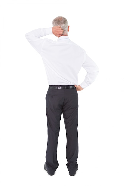 Businessman standing back to camera scratching his head