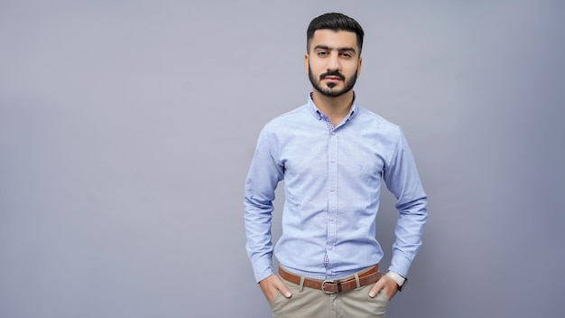 businessman standing in blue shirt with hands in pocket indian pakistani model