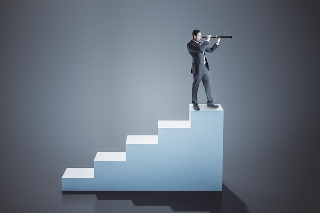 Businessman standing on concrete ladder