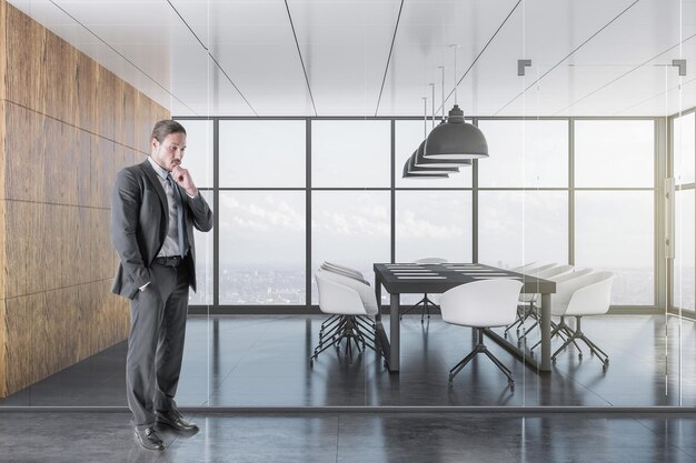 Businessman standing in luxury coworking office