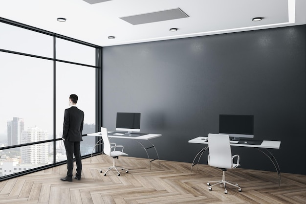 Businessman standing in office interior w