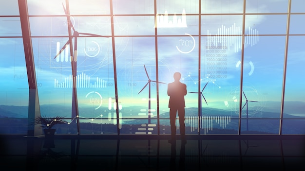 A businessman standing opposite virtual infographic data and panoramic window of his large office against the backdrop of a wind farm