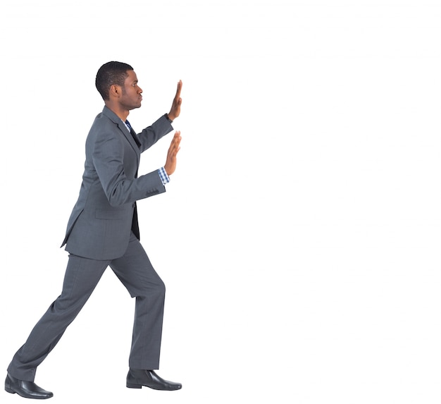 Businessman standing and pushing with hands