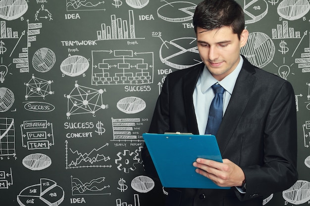 Businessman standing while reading report