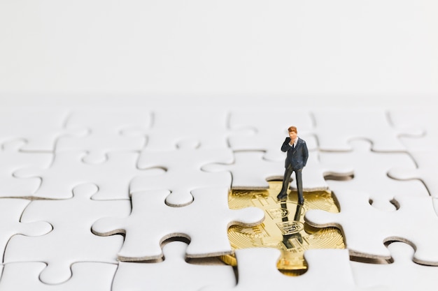  Businessman standing on white jigsaw. 