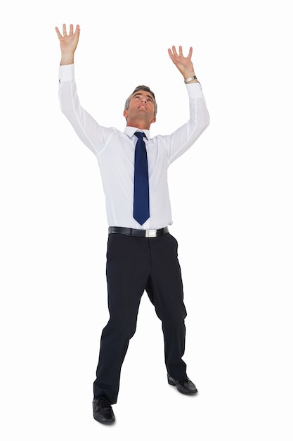 Businessman standing with arms up