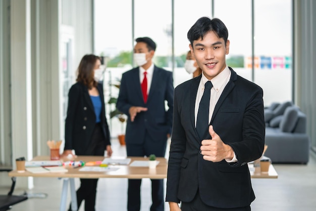 Businessman standing with thumbs up for meeting finish