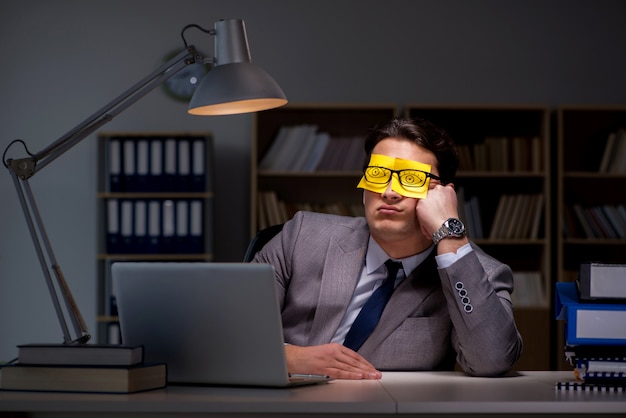 Businessman staying late to sort out priorities