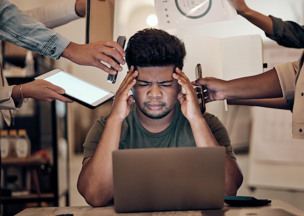 Businessman stress and headache on laptop multitasking team management or chaos in modern office Burnout mental health and challenge for worker employee or startup leader in work balance problem