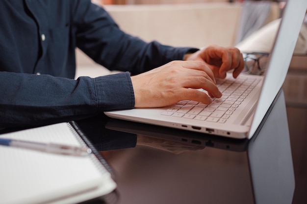 Businessman or student using laptop at home