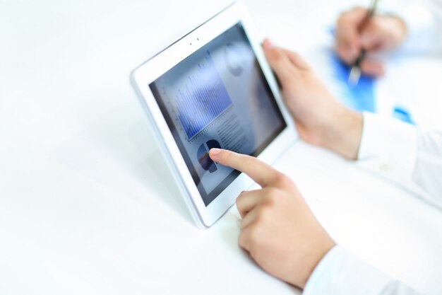 Businessman studying finance data on your tablet