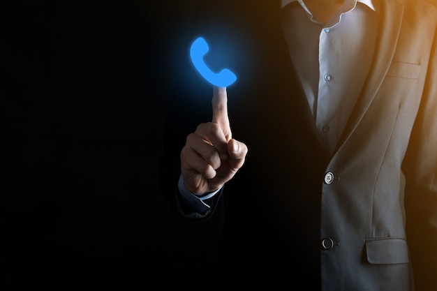 Businessman in suit on black background hold phone icon