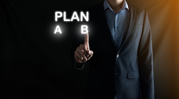 Businessman in a suit chooses options for plan development