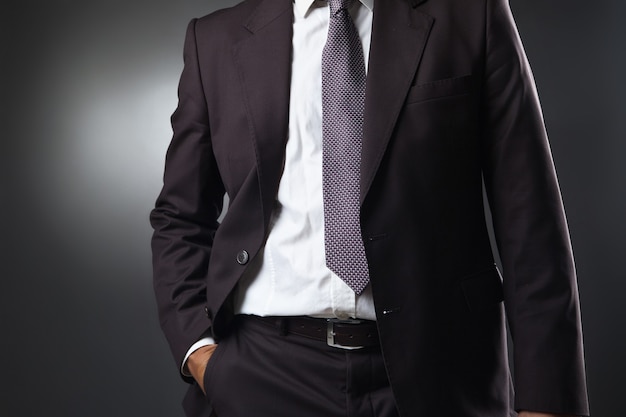 Businessman in suit on gray studio background