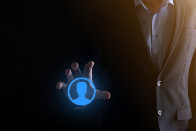 Businessman in suit holding out hand icon of user. Internet icons interface foreground. global network media concept,contact on virtual screens ,copy space.