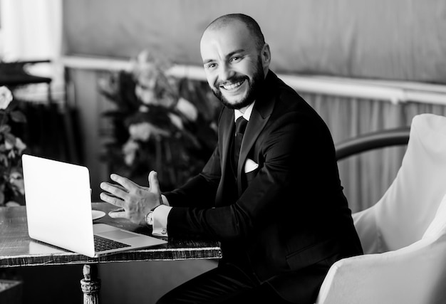 Businessman in suit is working with laptop