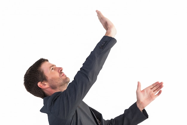 Photo businessman in suit pushing with hands