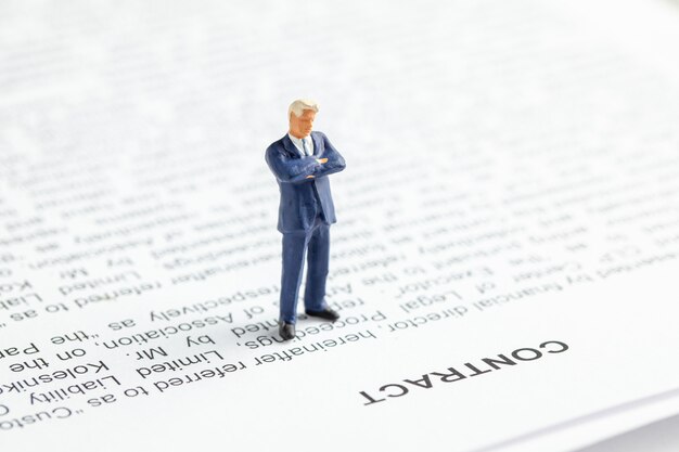 Photo businessman in a suit and tie ponders contract