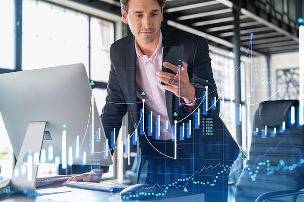 Businessman in suit using smart phone to optimize trading\
strategy at corporate finance fund forex chart hologram over modern\
panoramic office background