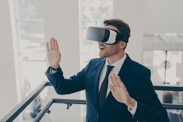 Businessman in suit using virtual reality glasses in office