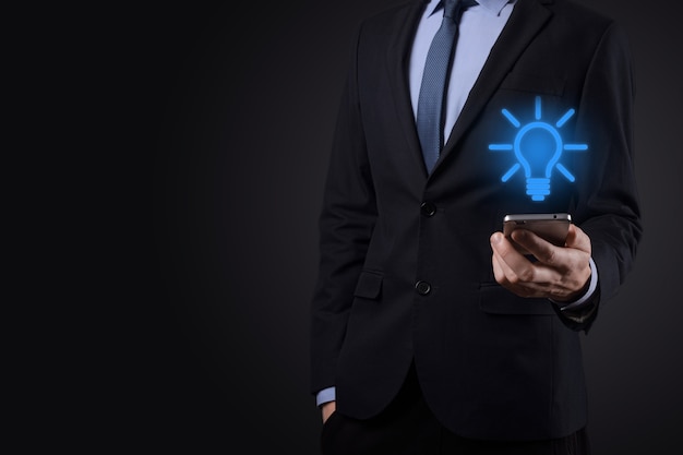 Businessman in a suit with a light bulb in his hands