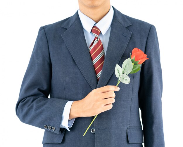 Businessman in suit with red rose on white 