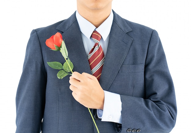 Foto uomo d'affari in vestito con la rosa rossa su bianco