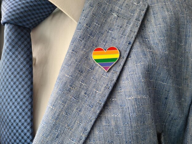 Businessman in a suit with sign of LGBT and lesbian gay bisexual and transgender people