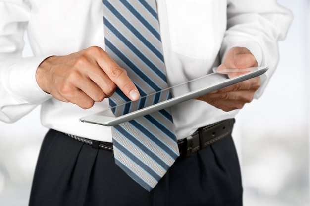 Businessman and tablet pc   on  background