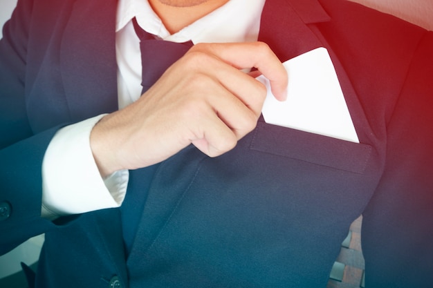 businessman takes out business card from the pocket of suit, copy space