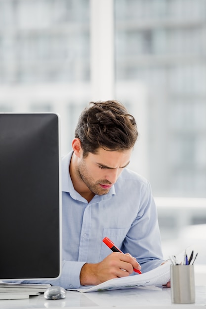 Businessman taking notes at his desk