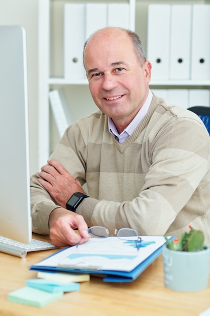 Businessman taking off glasses