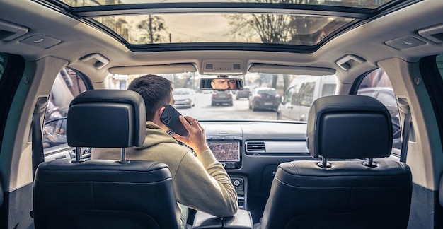 Businessman talking on cell phone while driving