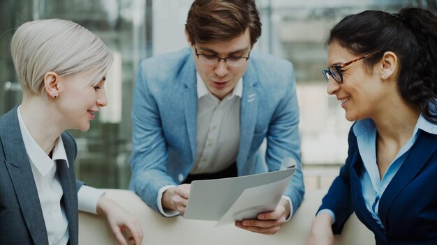 businessman talking and discussing about financial report with business female colleagues