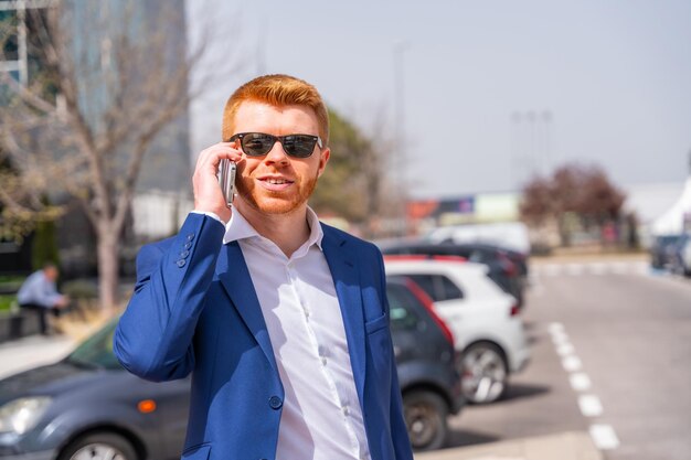 Businessman talking to the mobile in the city