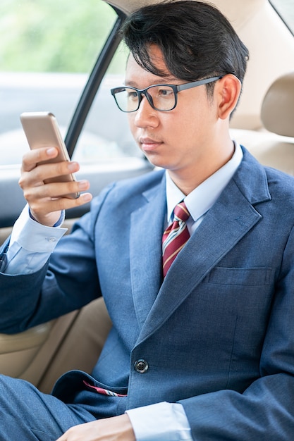 Businessman talking on the phone in car