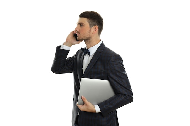 Businessman talking on phone and holds laptop, isolated on white background.