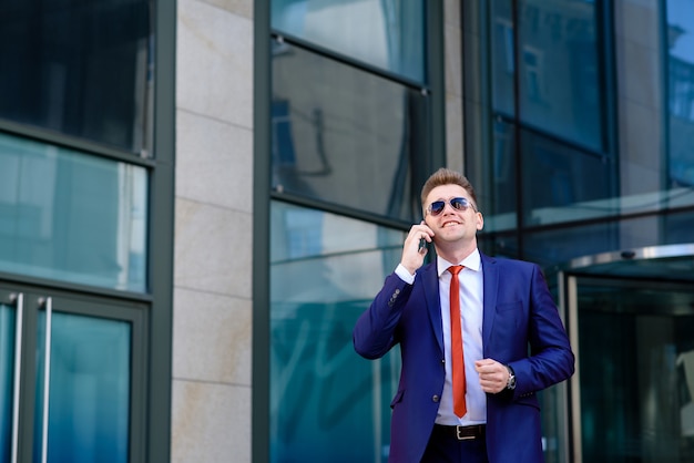 Businessman talking on the phone and smiling.