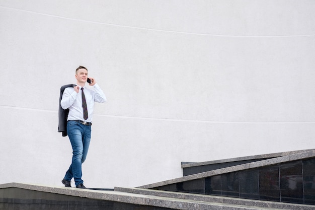 Businessman talking on the phone while walking