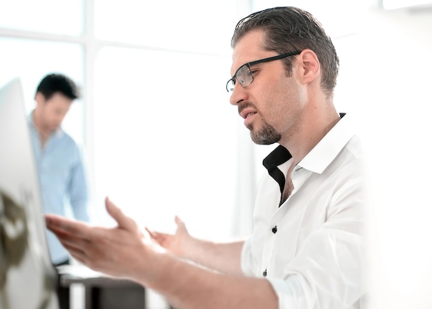 Businessman talking while sitting at his Desk