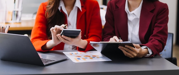 Businessman and team analyzing financial statement Finance task with smart phone and laptop and tablet Wealth management concept